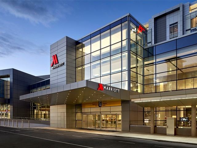 Exterior of Calgary Airport Marriott with glass facade and visible hotel signage.