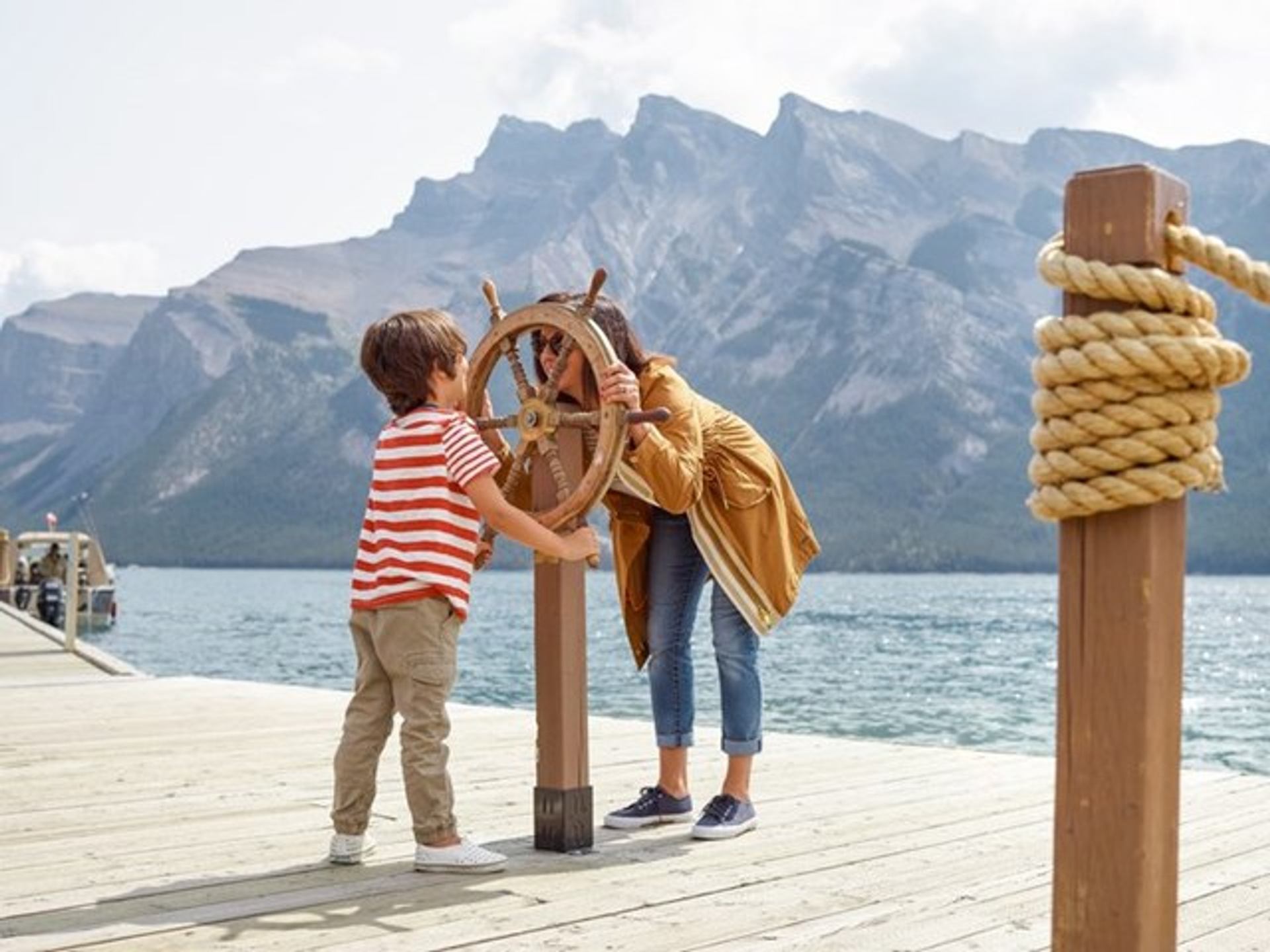 Mother and son playing on the dock waiting for a Lake Minnewanka Cruise.