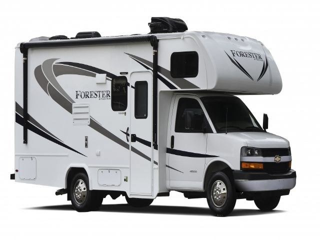 White and blue RV parked in wooded area with pine trees and Rangeland RV logo.