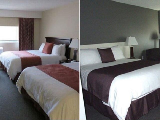 Hotel room beds with pillows and bedside lamps in a neutral grey and brown setting.