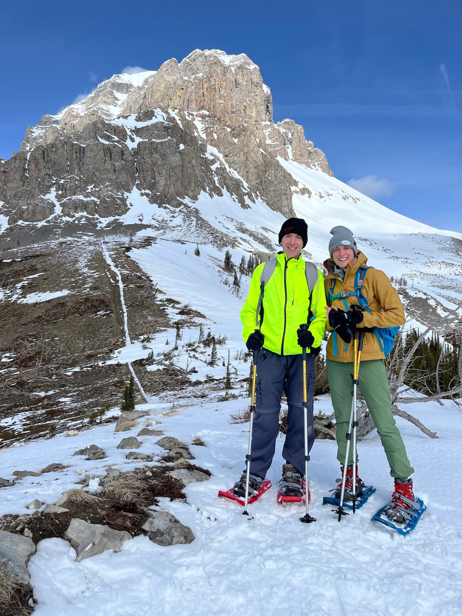 A young couple exploring via snowhsoes in Crowsnest Pass.