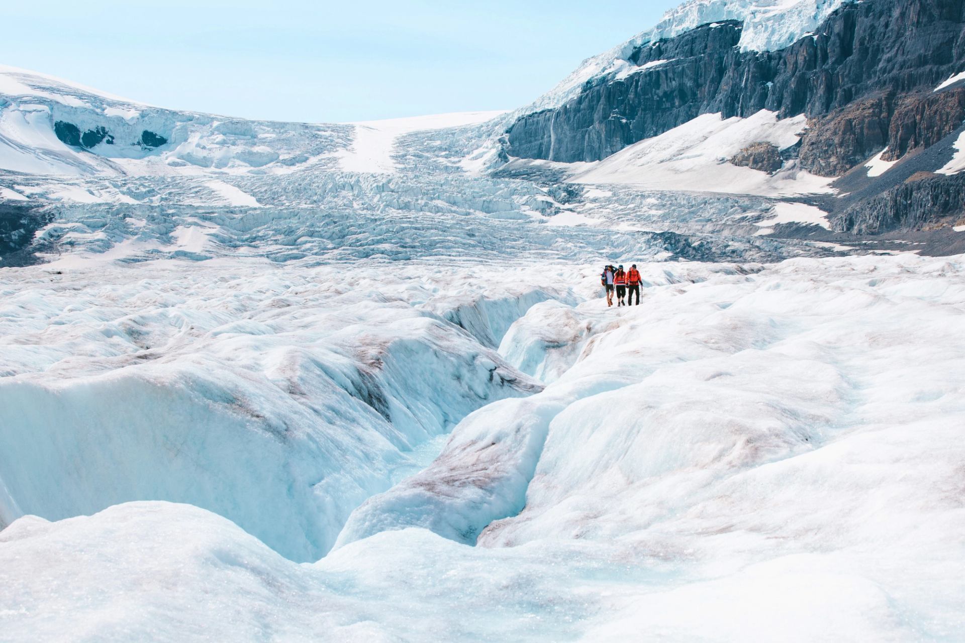 People hiking on a snow-covered glacier at the Columbia Icefield.