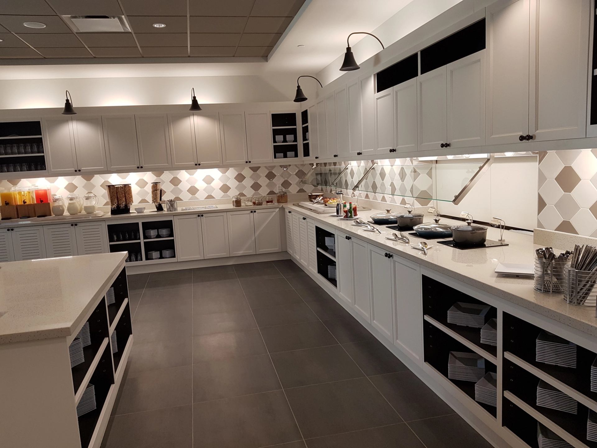 Hyatt Place kitchen with white cabinets and breakfast setup.