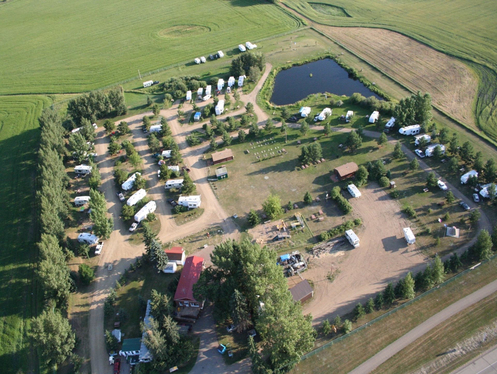RV sites and green space stretch across a peaceful campground at Wetaskiwin Lions RV Campground.