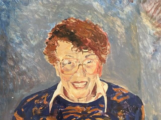 Close-up of a painted portrait displayed inside the art centre.
