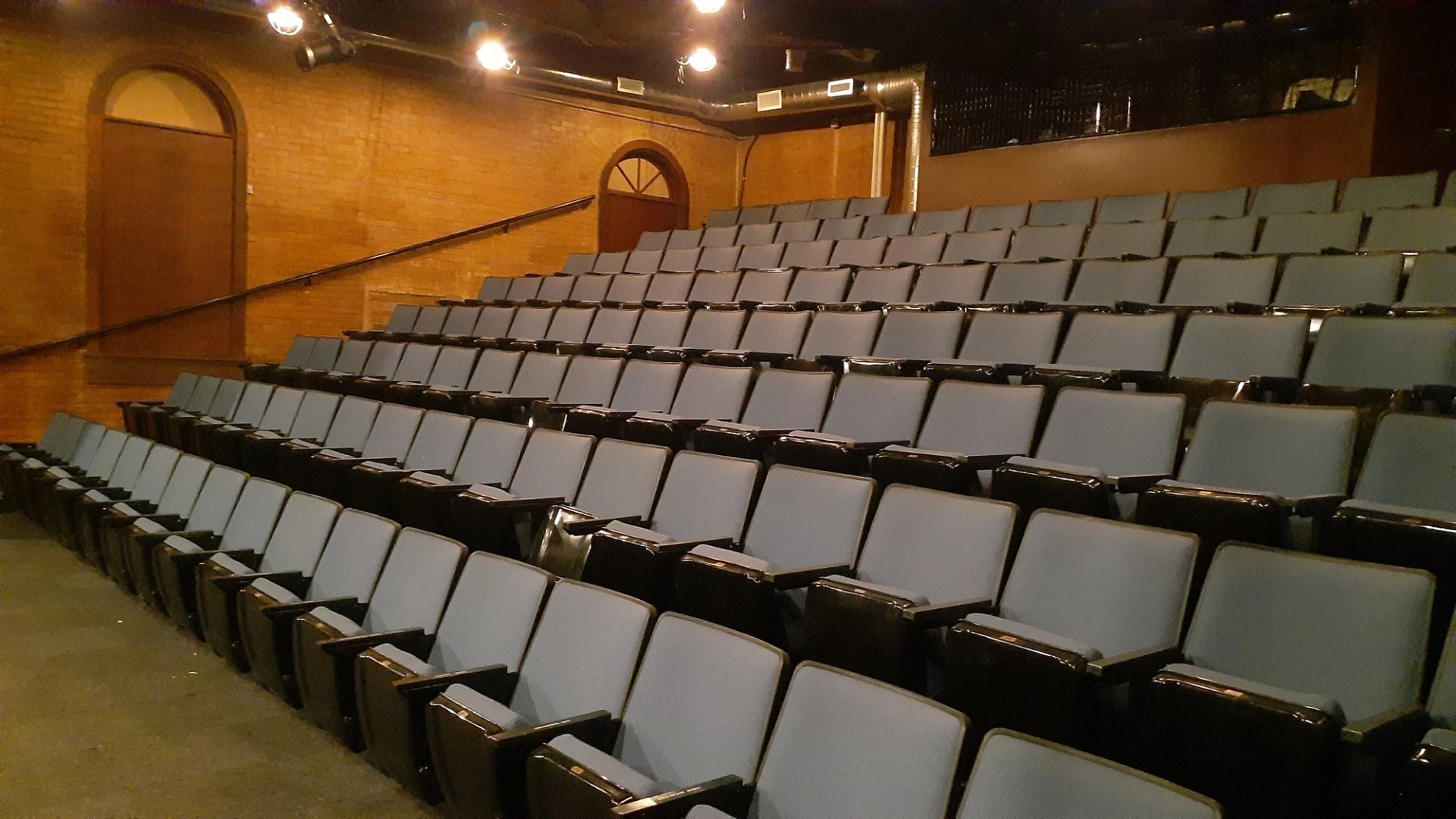 Tiered theatre seating inside the Manluk Theatre auditorium.
