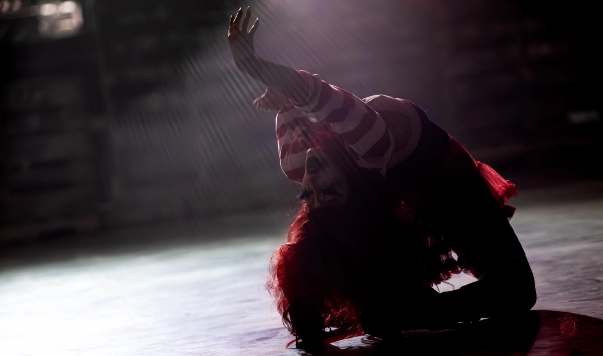 Decimate Metalfest features a performer in costume bent backward under a spotlight on a dim stage floor.