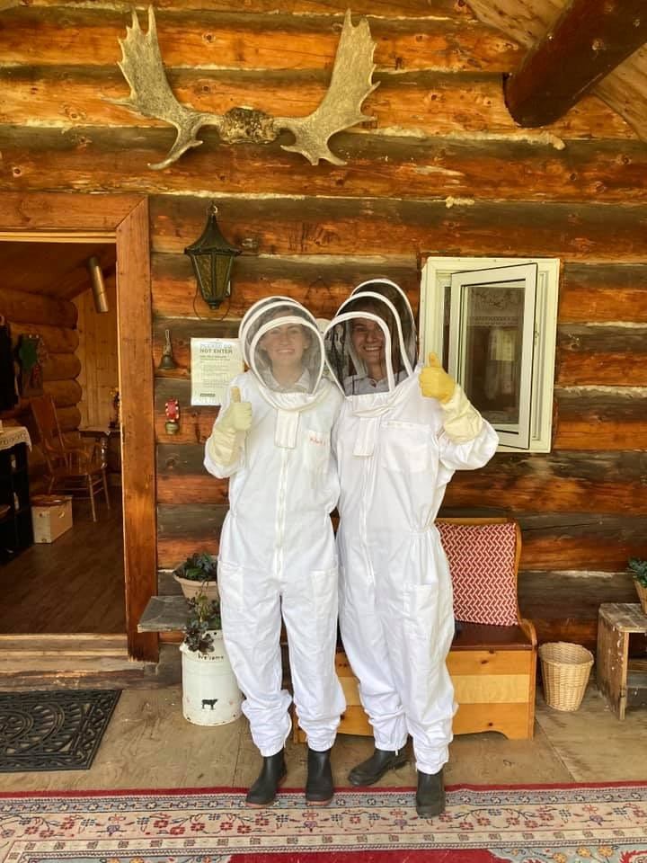 Two people in beekeeper suits