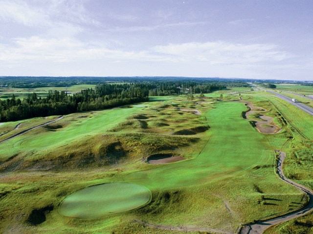 Golf course fairways with sand traps and a winding path at Wolf Creek Golf Resort.