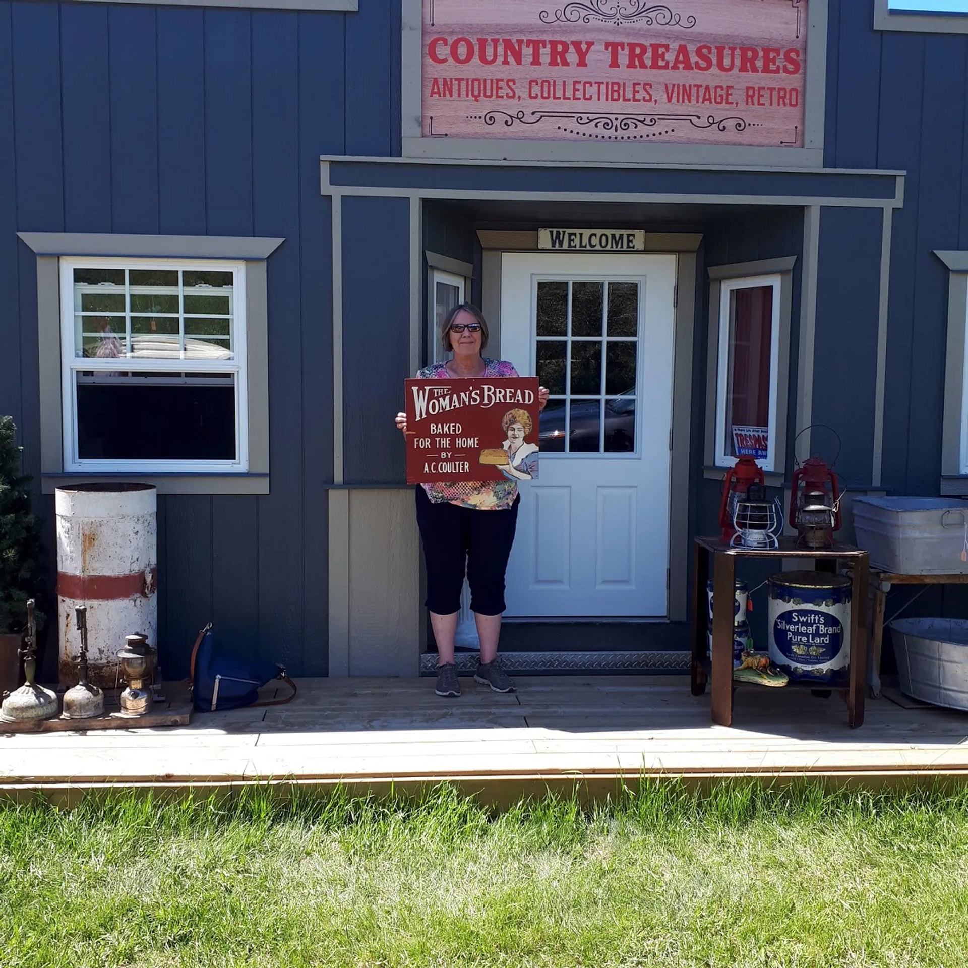 Country Treasures storefront with fresh bread sign, rustic decor, red chairs, and vintage charm.