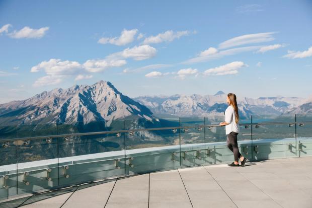 Visitor looking out over Banff National park from the top of Sulphur Mountain.