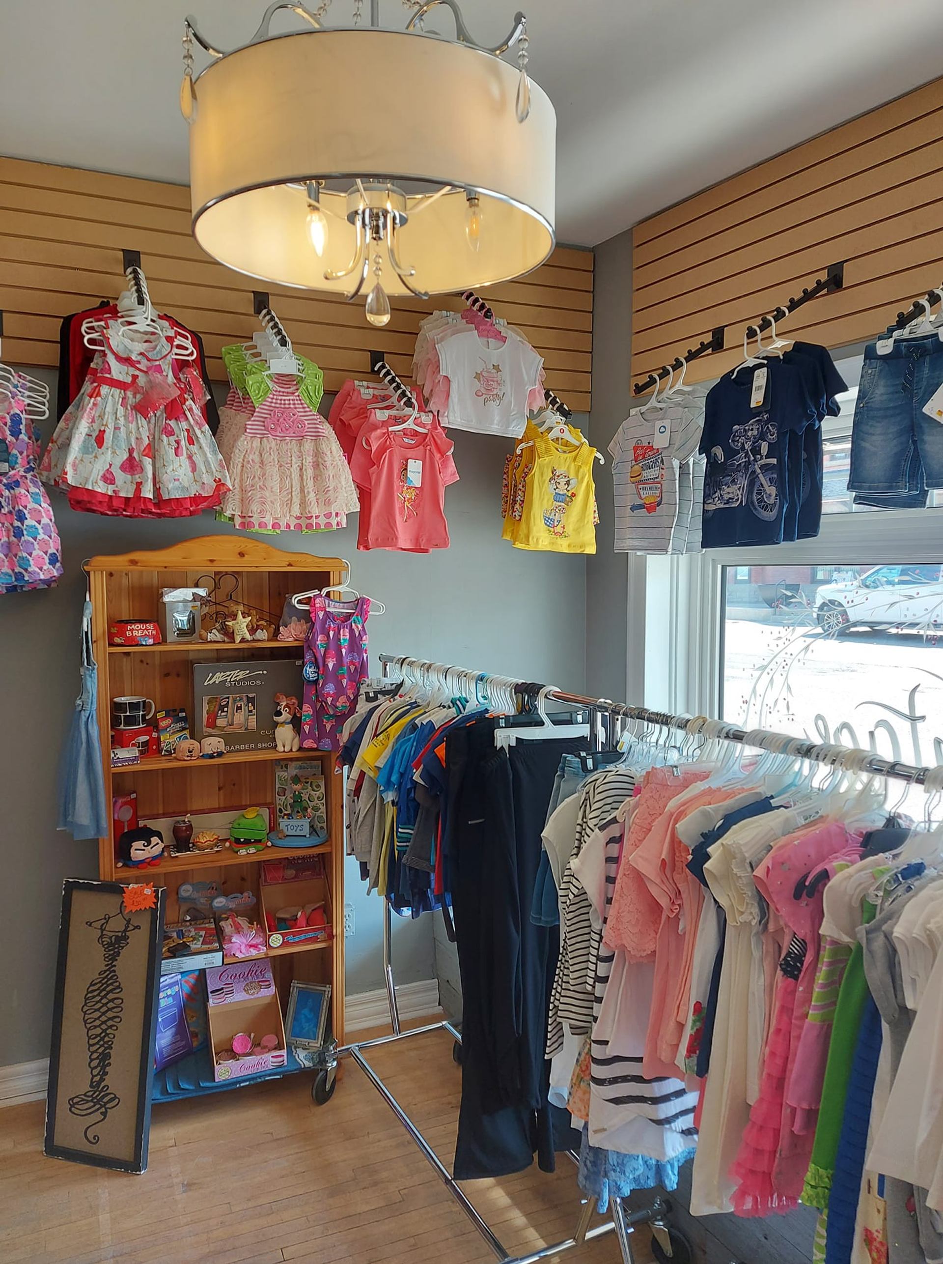Bright interior of Runwayz Boutique with racks of kids clothing and accessories.