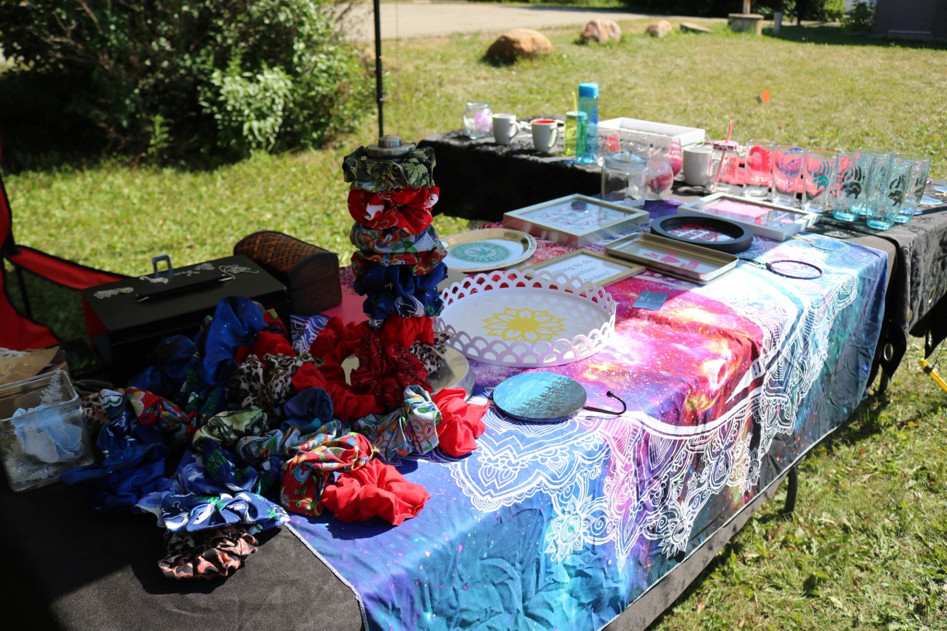 A vendor table covered with scrunchies, art pieces, and handmade goods.