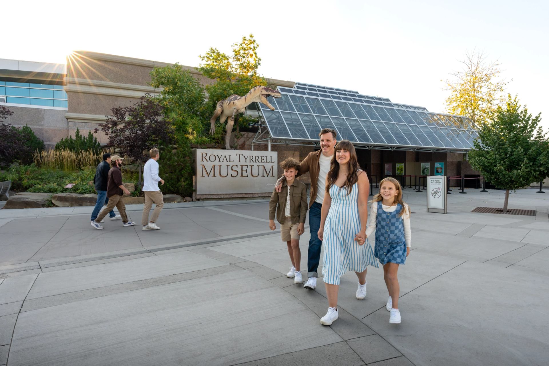 Family leaving the Royal Tyrrell Museum on a sunny day.