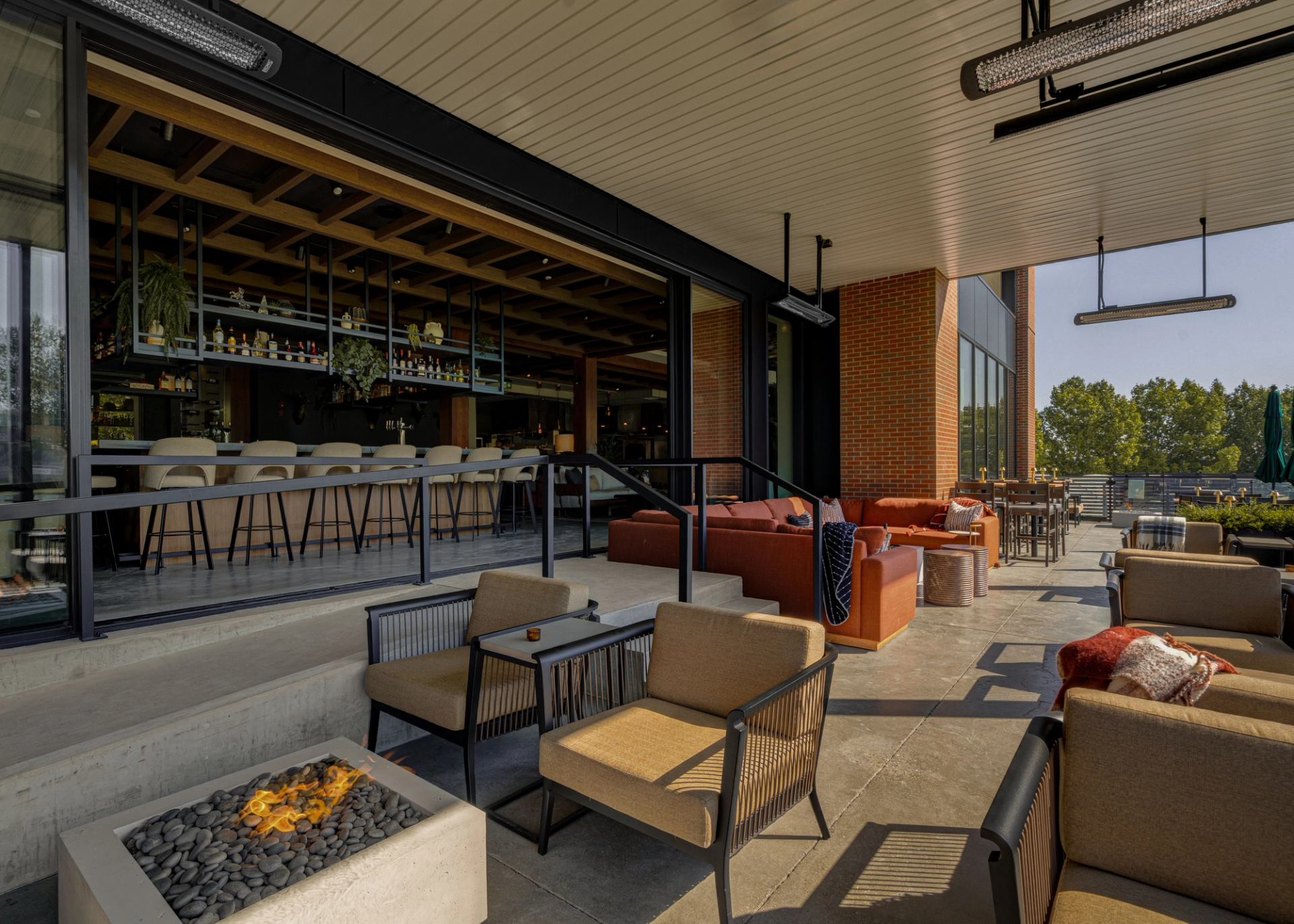 Foxtrot at Spruce Meadows patio with lounge seating, fire feature, and open bar visible inside.