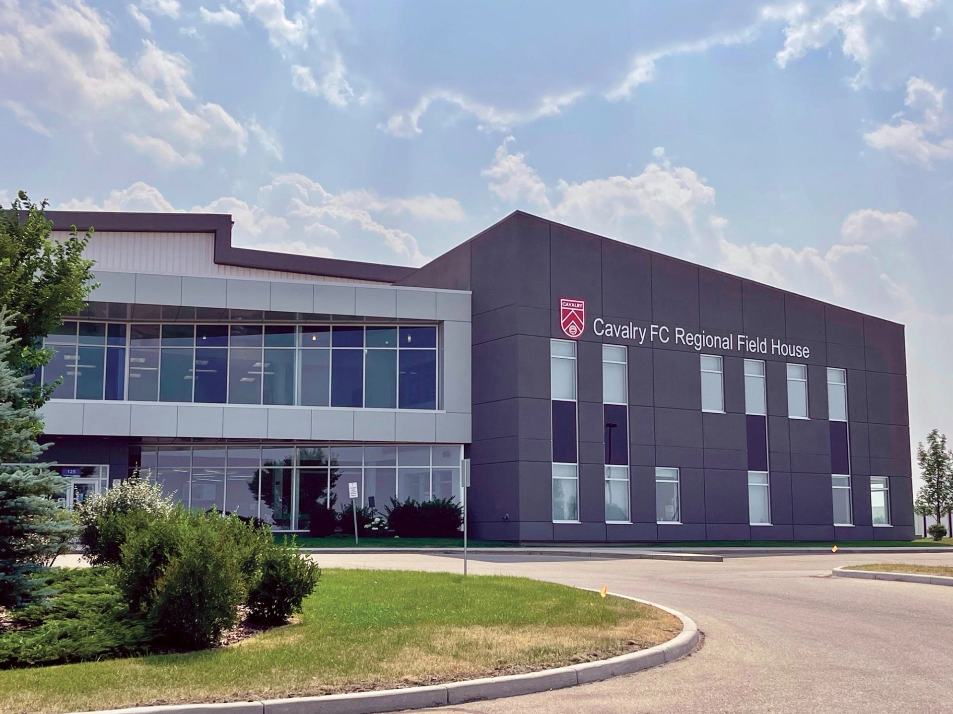 egional Field House with large windows and landscaped exterior.