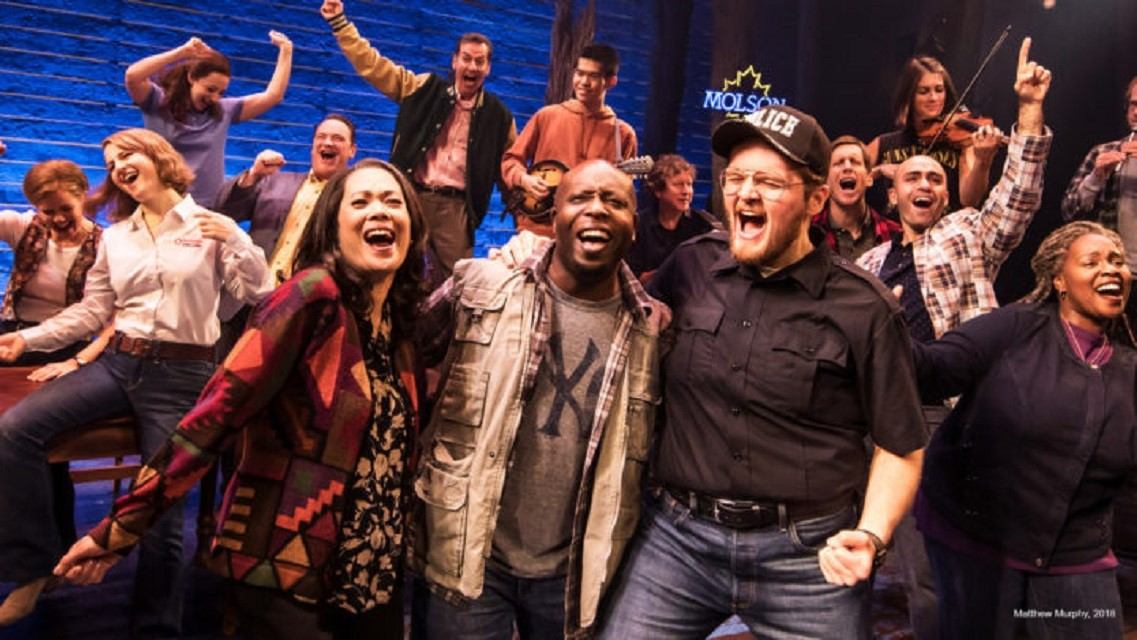 Audience members cheering on stage at Broadway Across Canada theatre performance in Calgary.