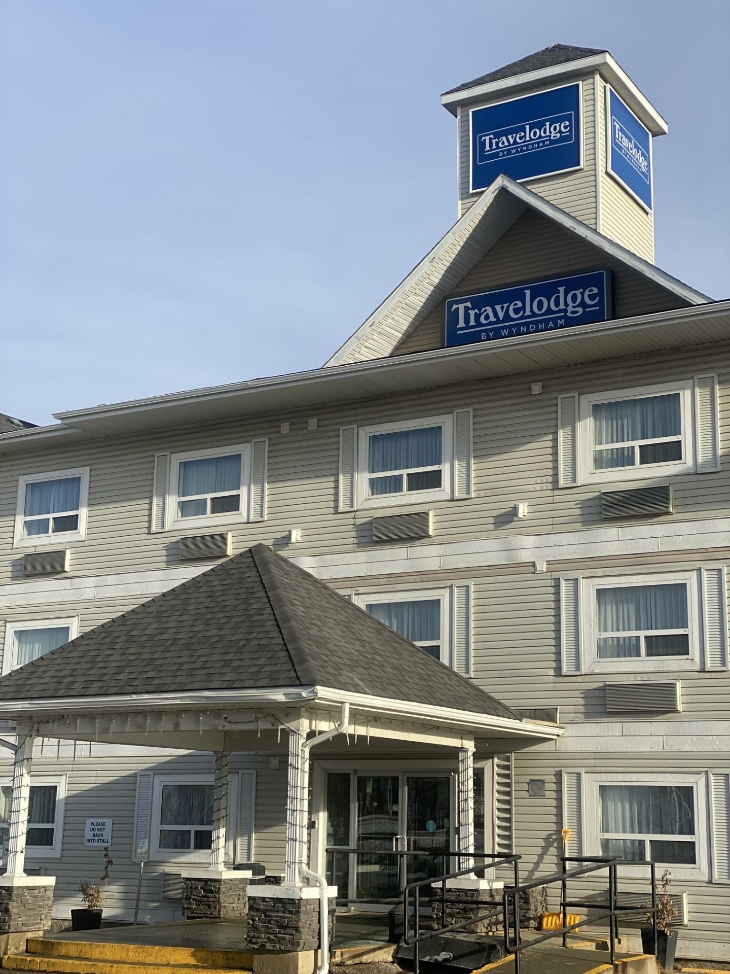 Travelodge hotel exterior with tower logo and covered entrance.