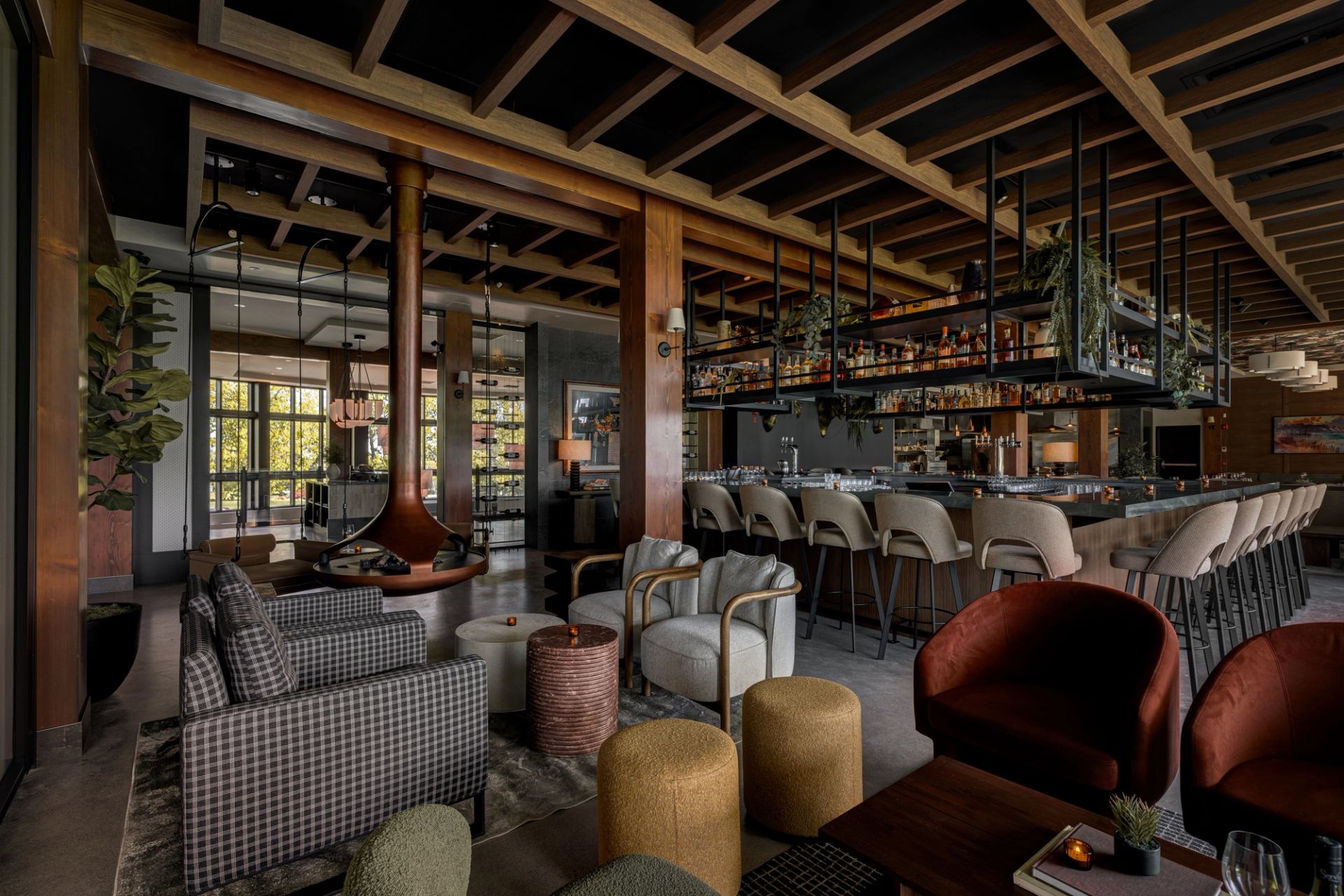 Interior of Foxtrot at Spruce Meadows with wood beams, bar seating, and cozy lounge chairs.