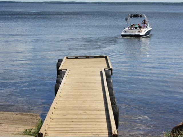 A boat going off the dock at the lake