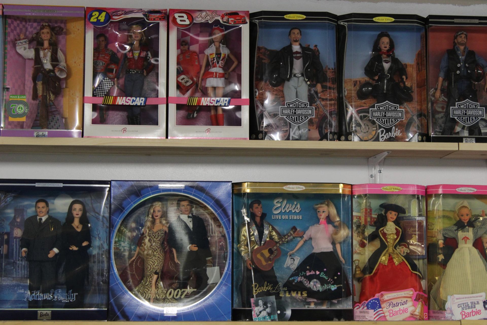 Shelves displaying boxed collectible dolls, including themed and special edition designs.
