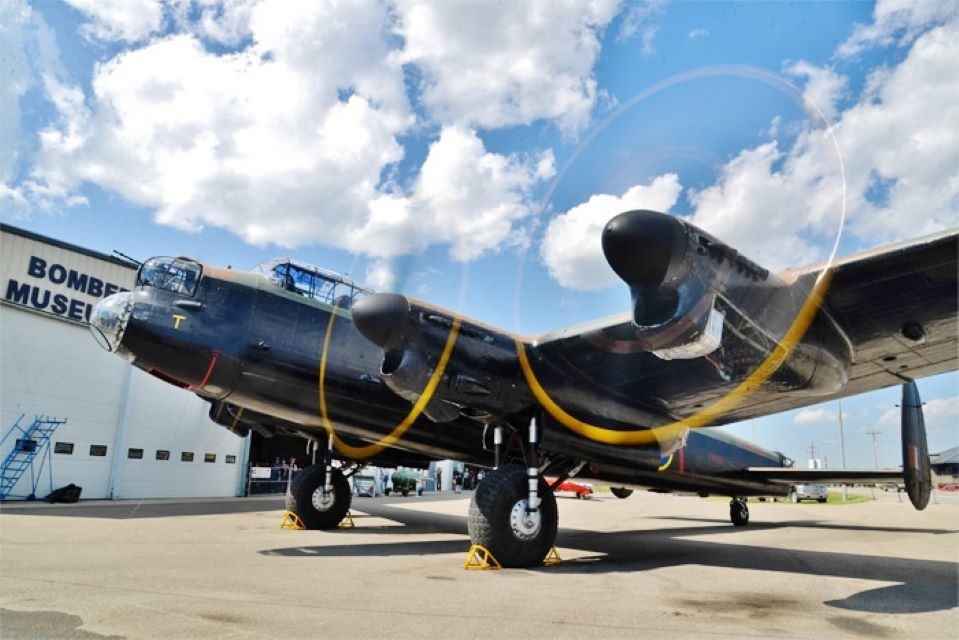 Bomber Command Museum aircraft on display outside, with propellers and nose visible against sky.