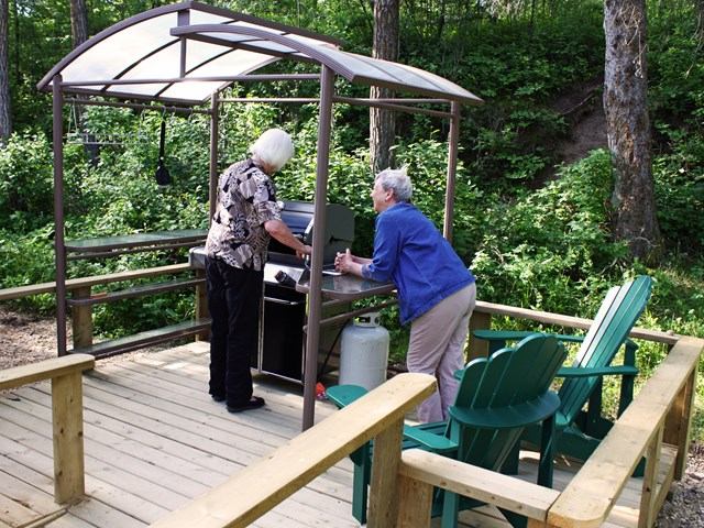 Two people having a bbq at the yurt