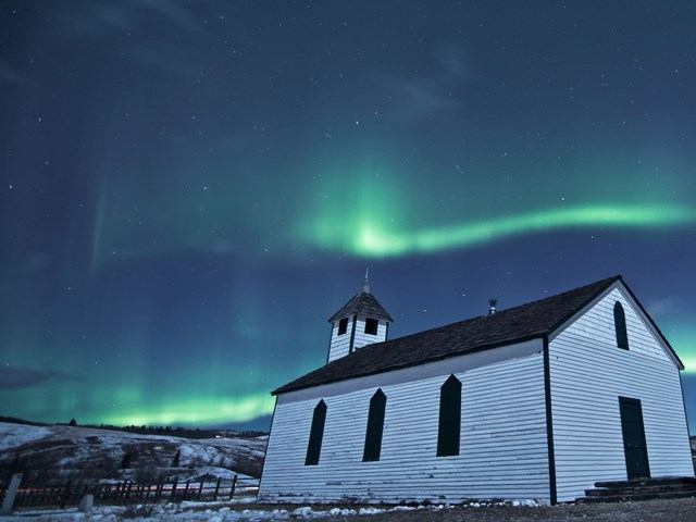 The church at night with the Aurora Borealis above.
