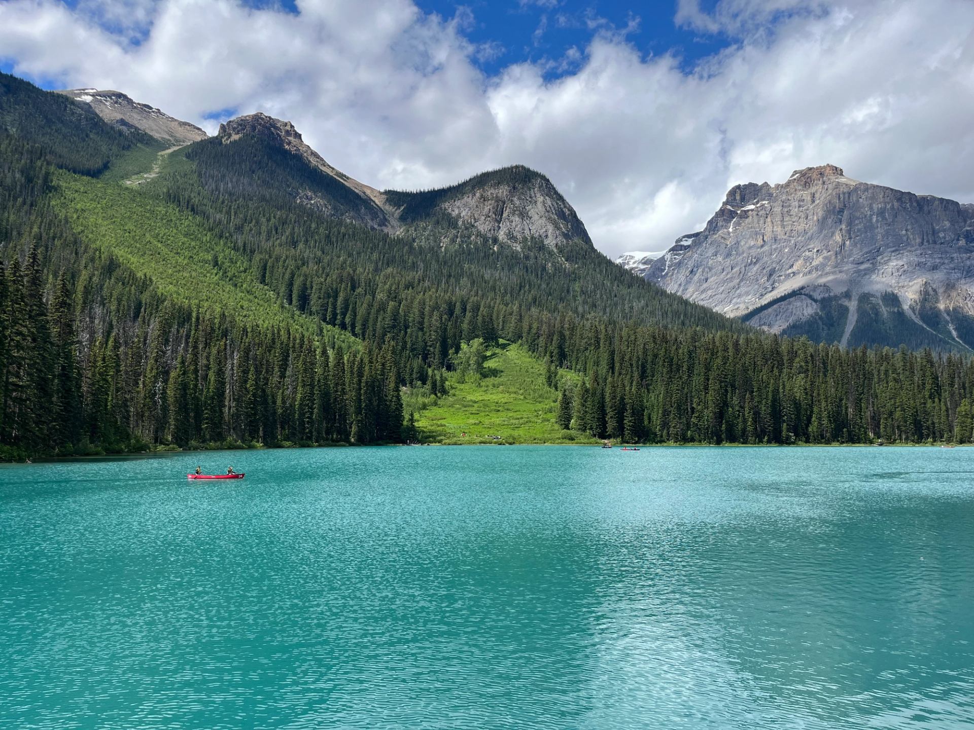 Emerald Lake with turquoise water, forested shorelines, and rocky mountain peaks.