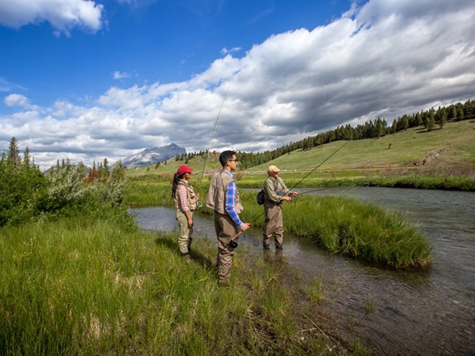 Man teaching visitors how to fly fish.