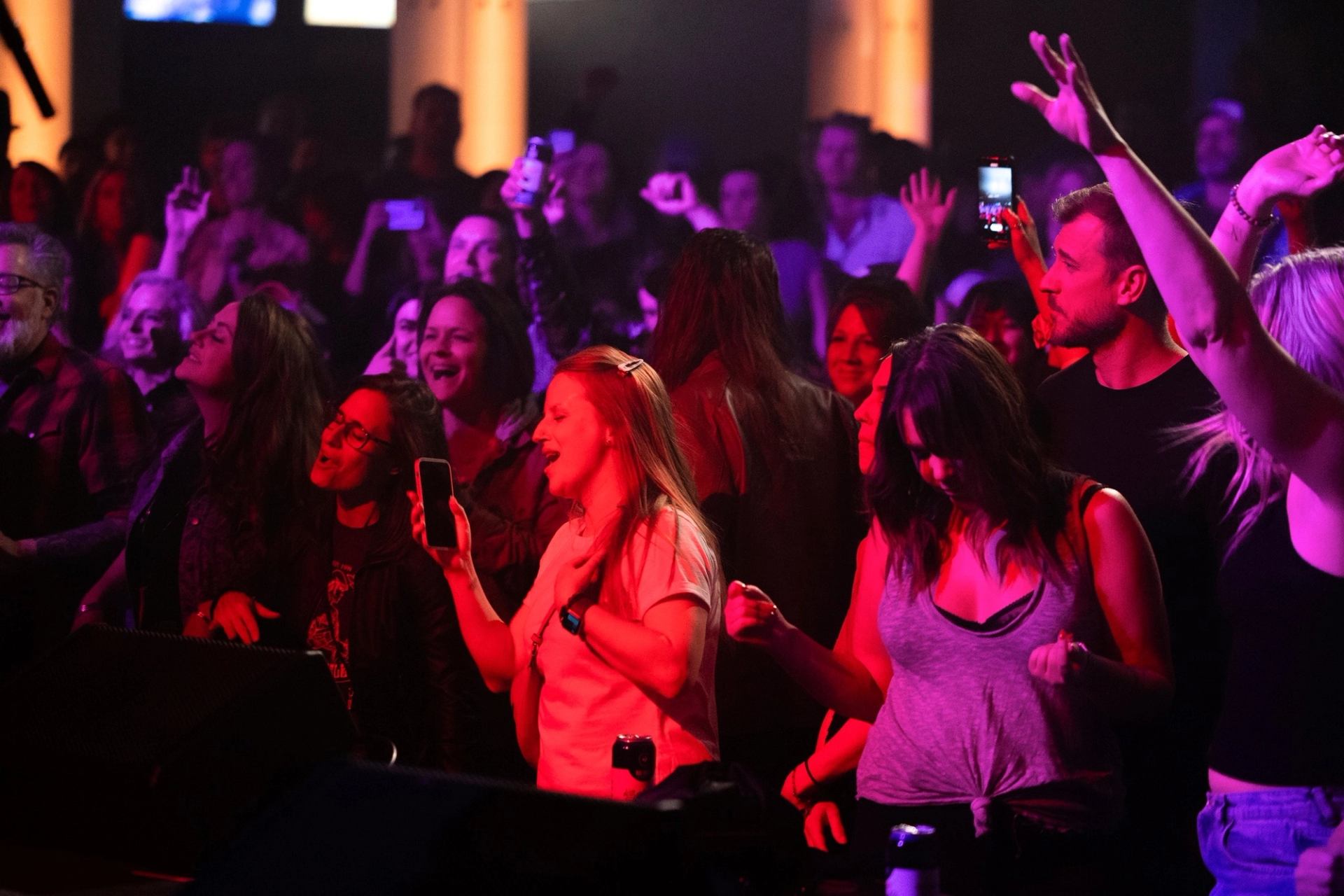Crowd enjoying live music under colorful stage lights at Block Heater.