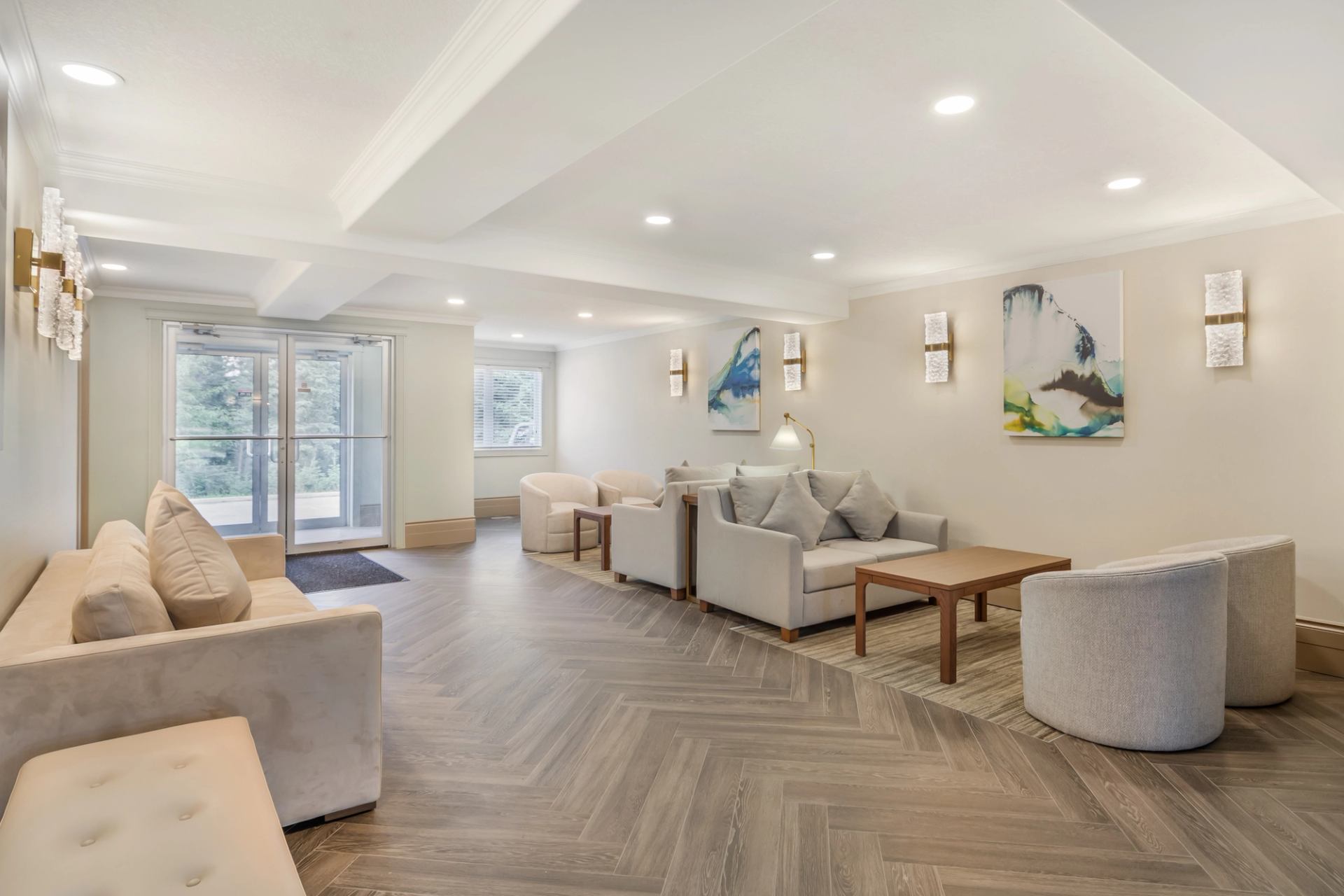 Bright, modern hotel lobby with cozy seating, neutral tones, and contemporary artwork.