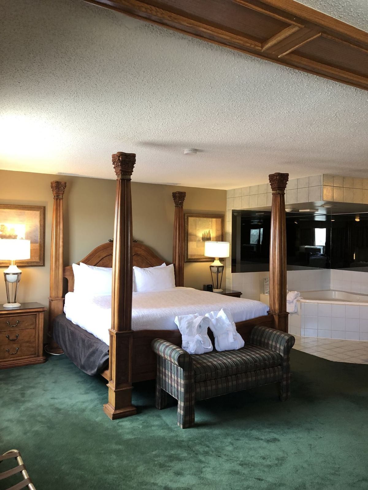 Elegant Nomad Hotel suite with four-poster bed and in-room jacuzzi.