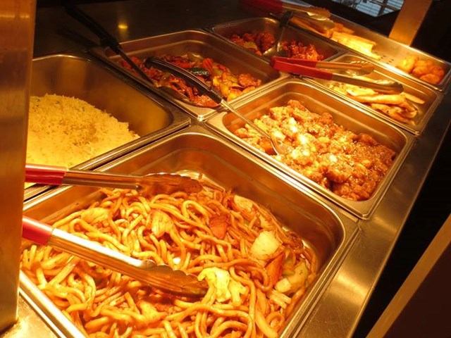 Buffet trays with noodles, rice, meats, and vegetables at Happy Valley Restaurant.