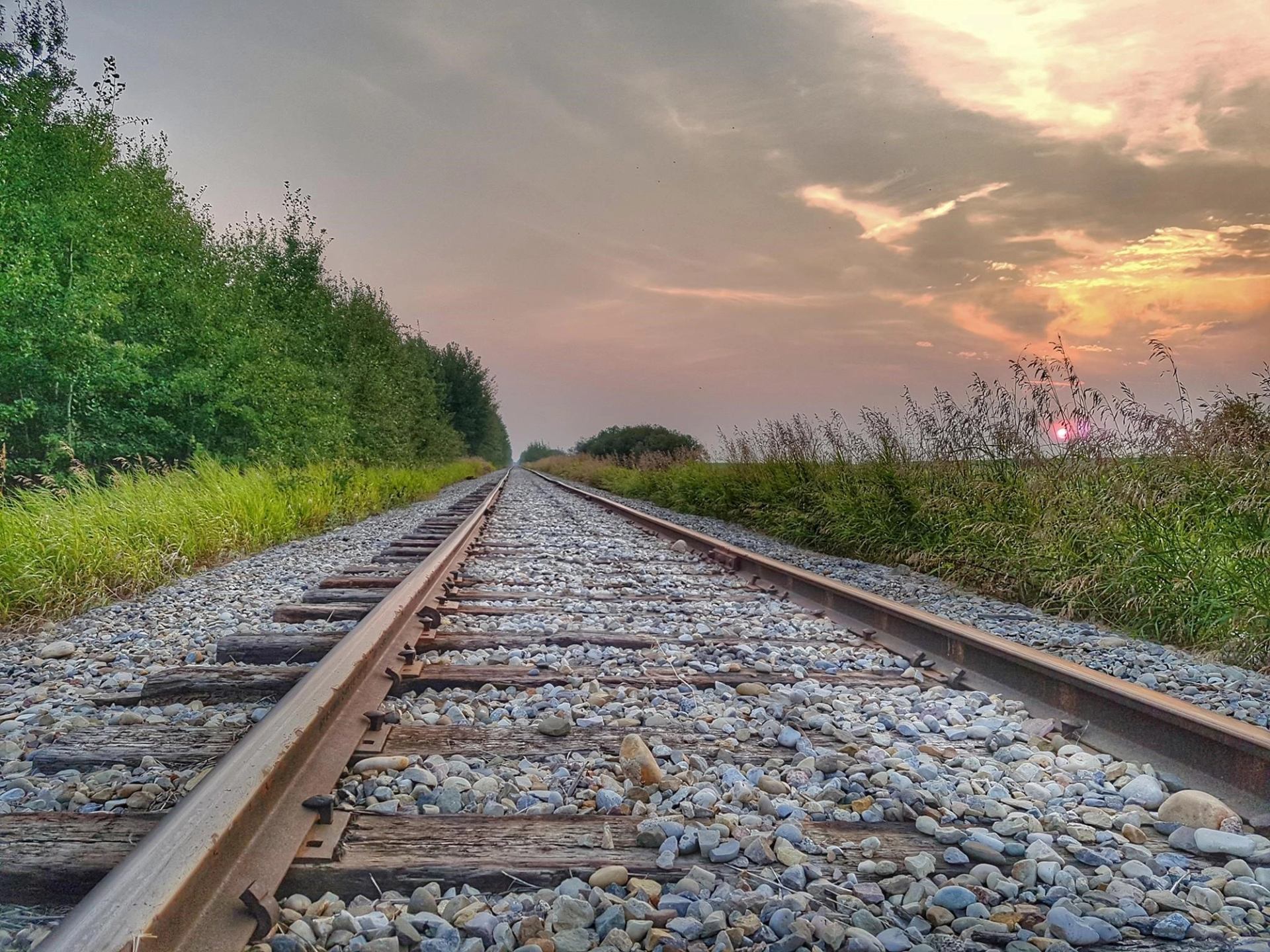 Train track with the sunset in the background.