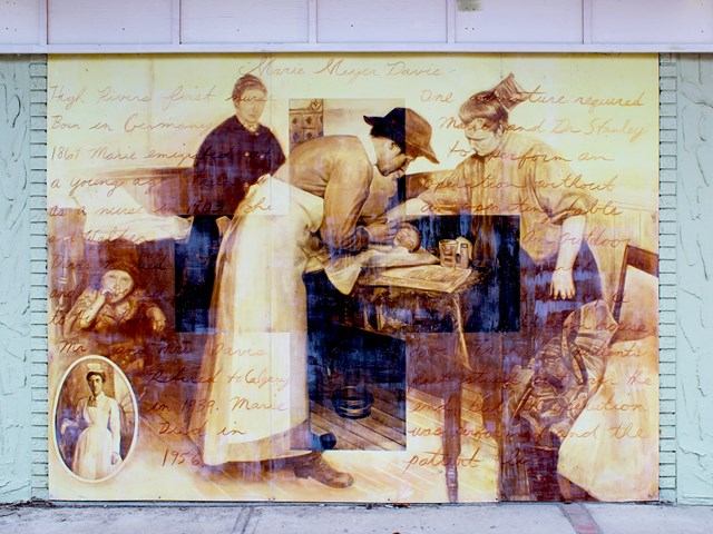 Sepia mural of historical figures at work with handwritten text and vintage photo.