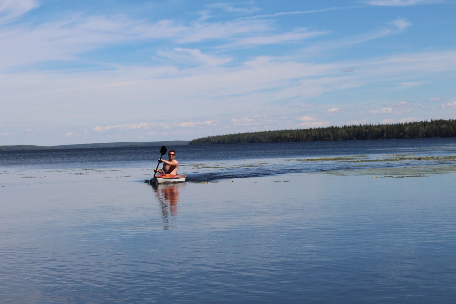 A man paddling his kayak on Fawcett Lake.