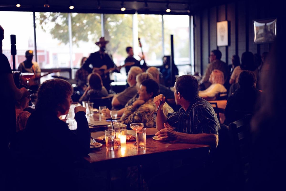 Crowd enjoying live music inside Latitude 55 Distillery and Lounge.