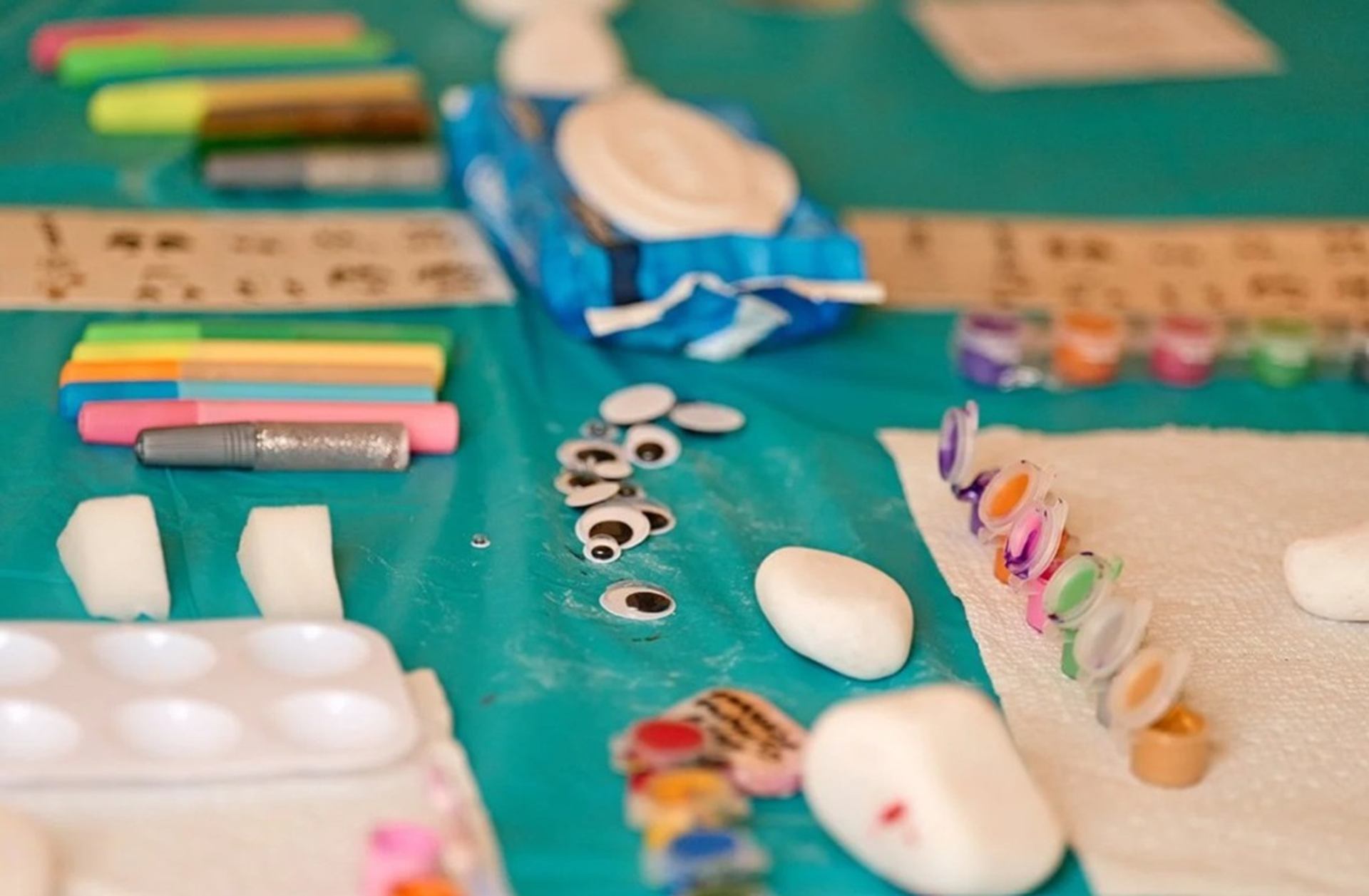 Table set with kids’ craft supplies at cultural event