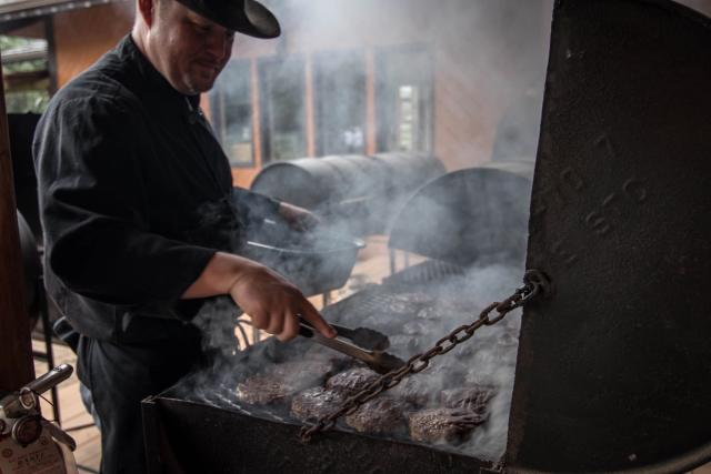 A man cooking steaks at Rick Guinn’s Steakhouse & Patio.