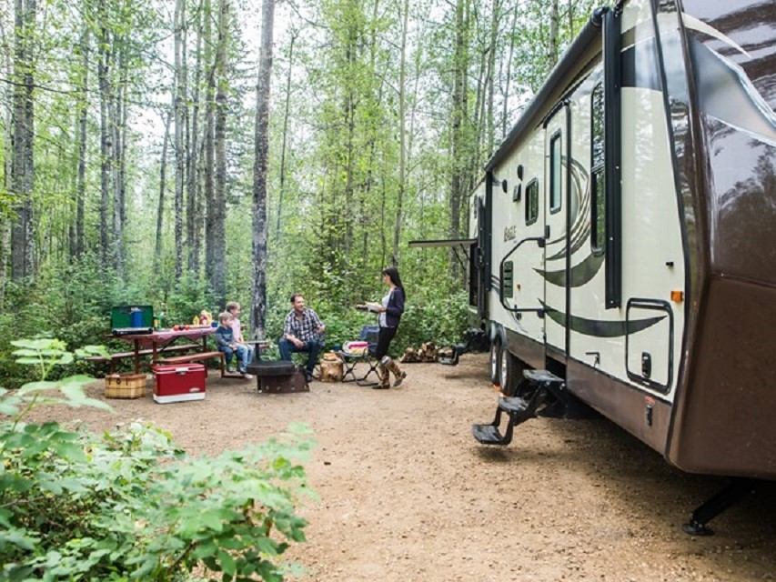 A family and their large RV at a campsite in Marten River.