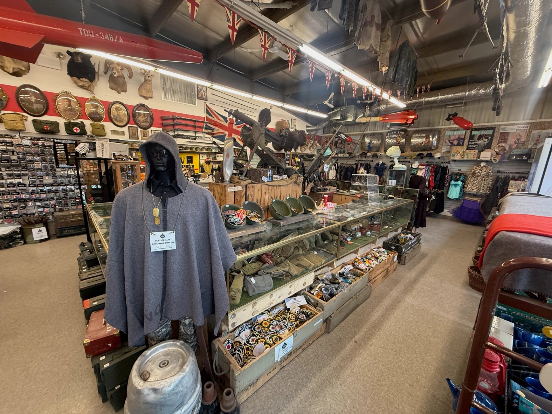 Crown Surplus Store interior shows glass cases with insignia, mannequin in poncho, and vintage military decor.