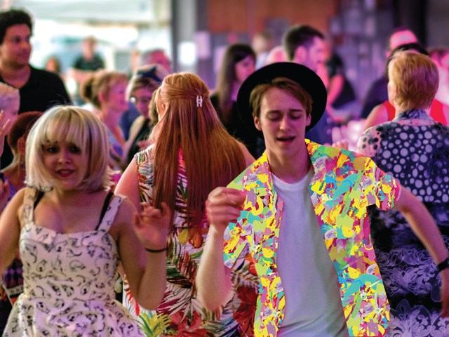 Crowd dancing in colorful attire at Medicine Hat JazzFest.