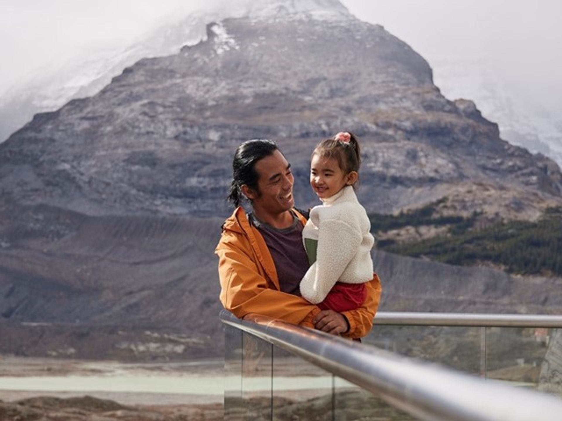 Father and daughter enjoying view of the Columbia Icefield from the Glacier Discovery Centre.