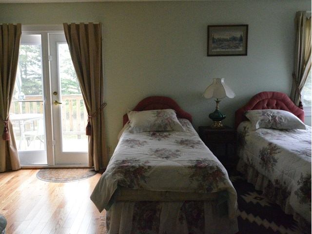 Two twin beds in the room and a patio door