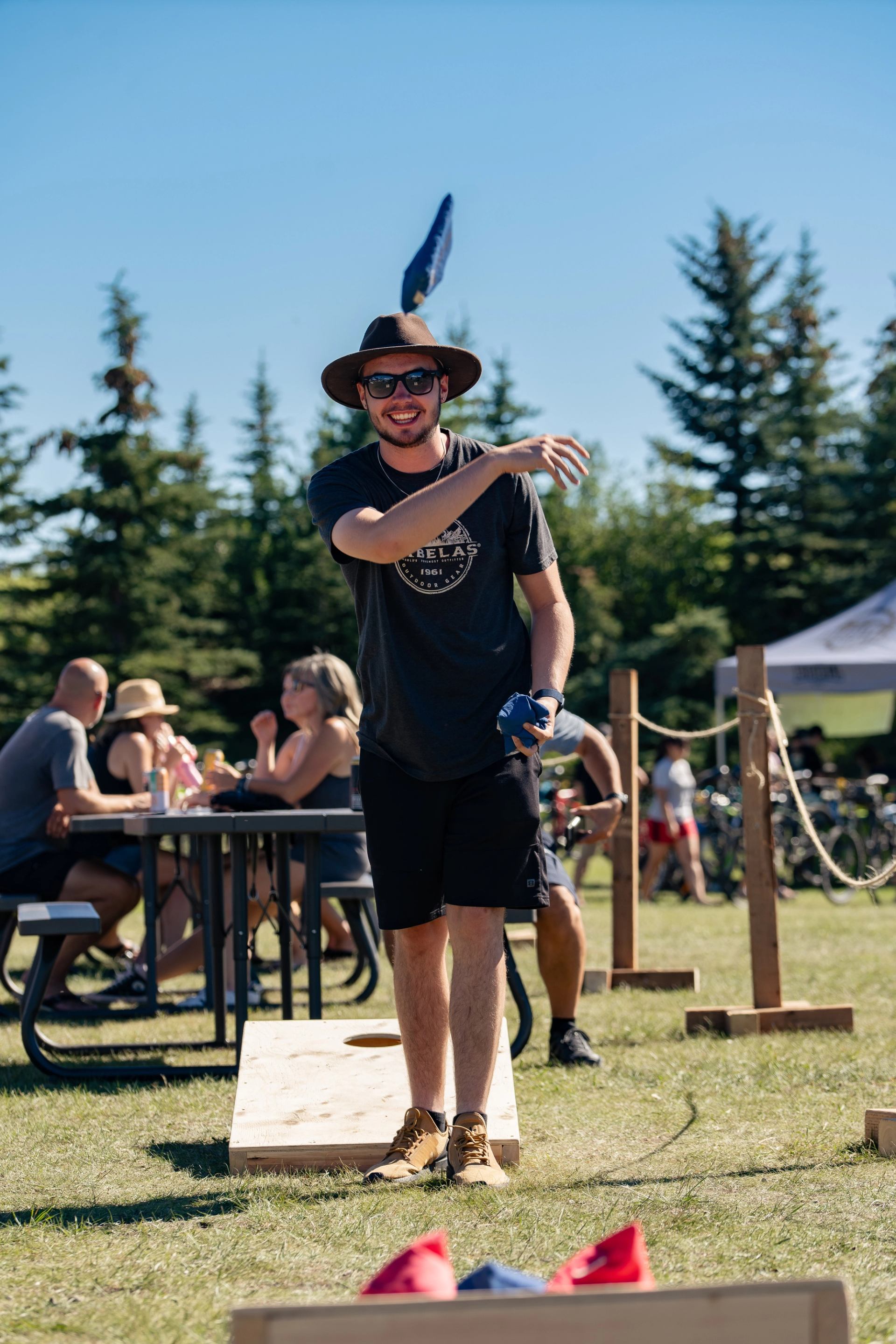 A person playing cornhole.
