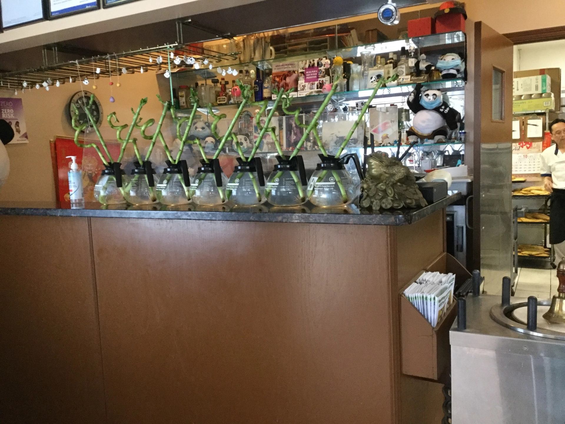 Coffee counter with glass pots, green handles, and café equipment at Happy Valley.