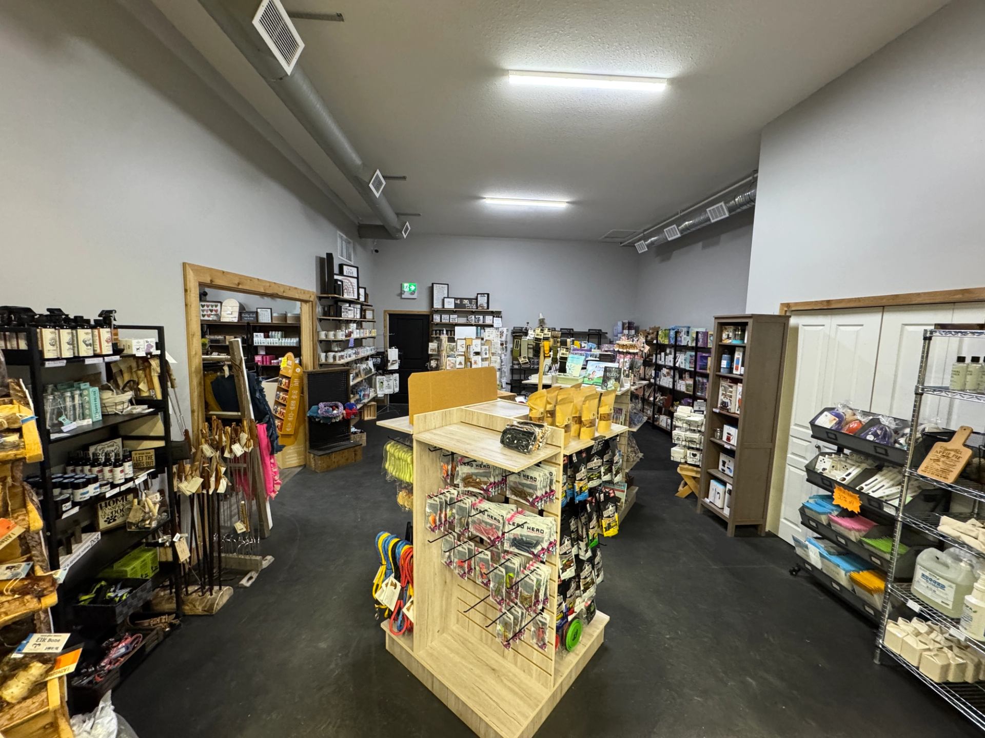 Interior of Farmstead Market & More with aisles of food, household goods, and merchandise.