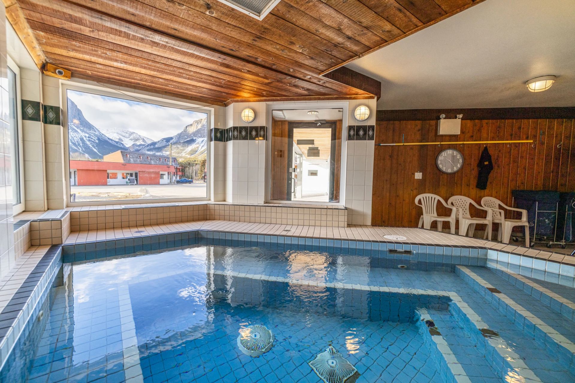 Indoor hot pool with tiled walls and wooden ceiling at Rocky Mountain Ski Lodge.