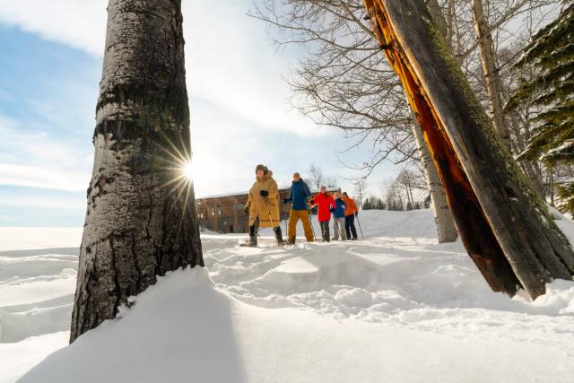 Indigenous Knowledge Keeper and  Mahikan Trails owner Brenda Holder guides visitors on a snowhshoe walk through the forest.